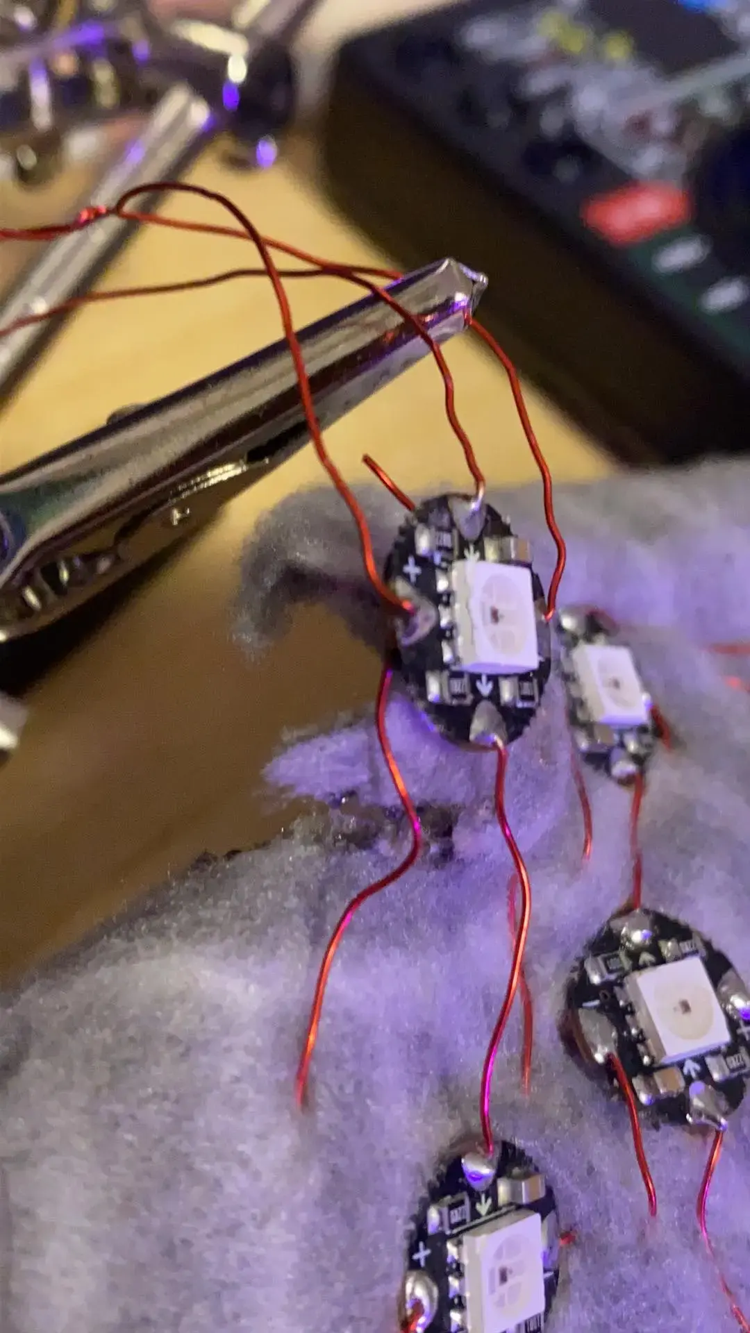 Some LEDs on a circuit board with delicate wire connecting them