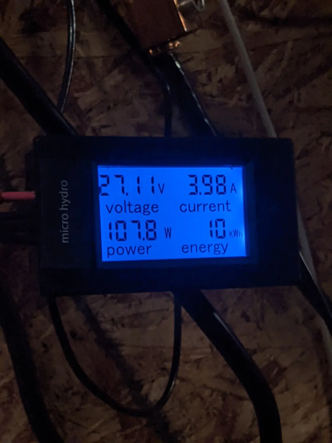 A power meter showing 60W from the hydroelectric system