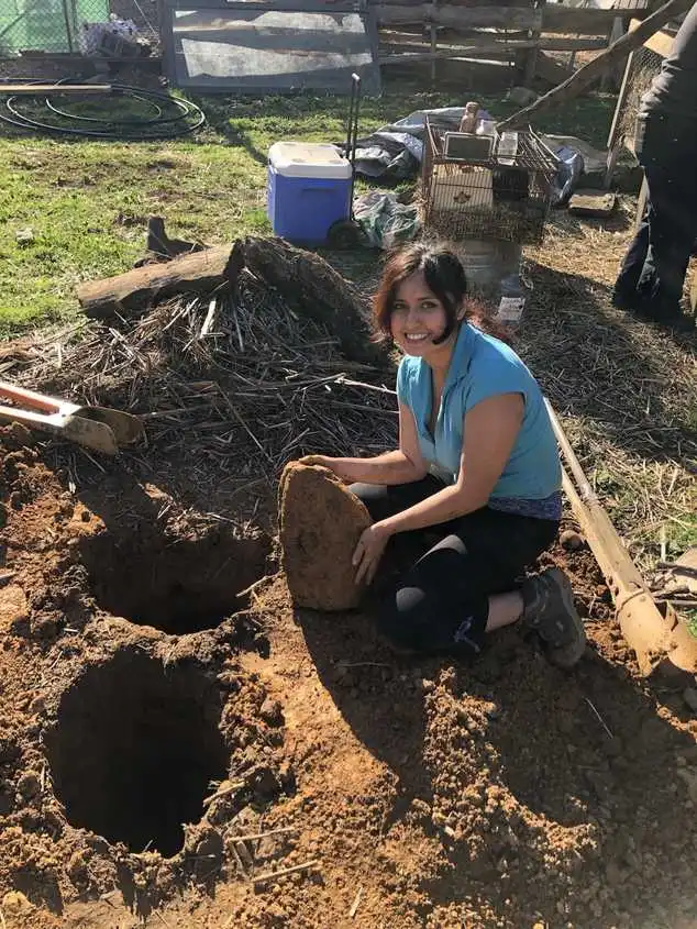 Me next to two giant holes we dug!