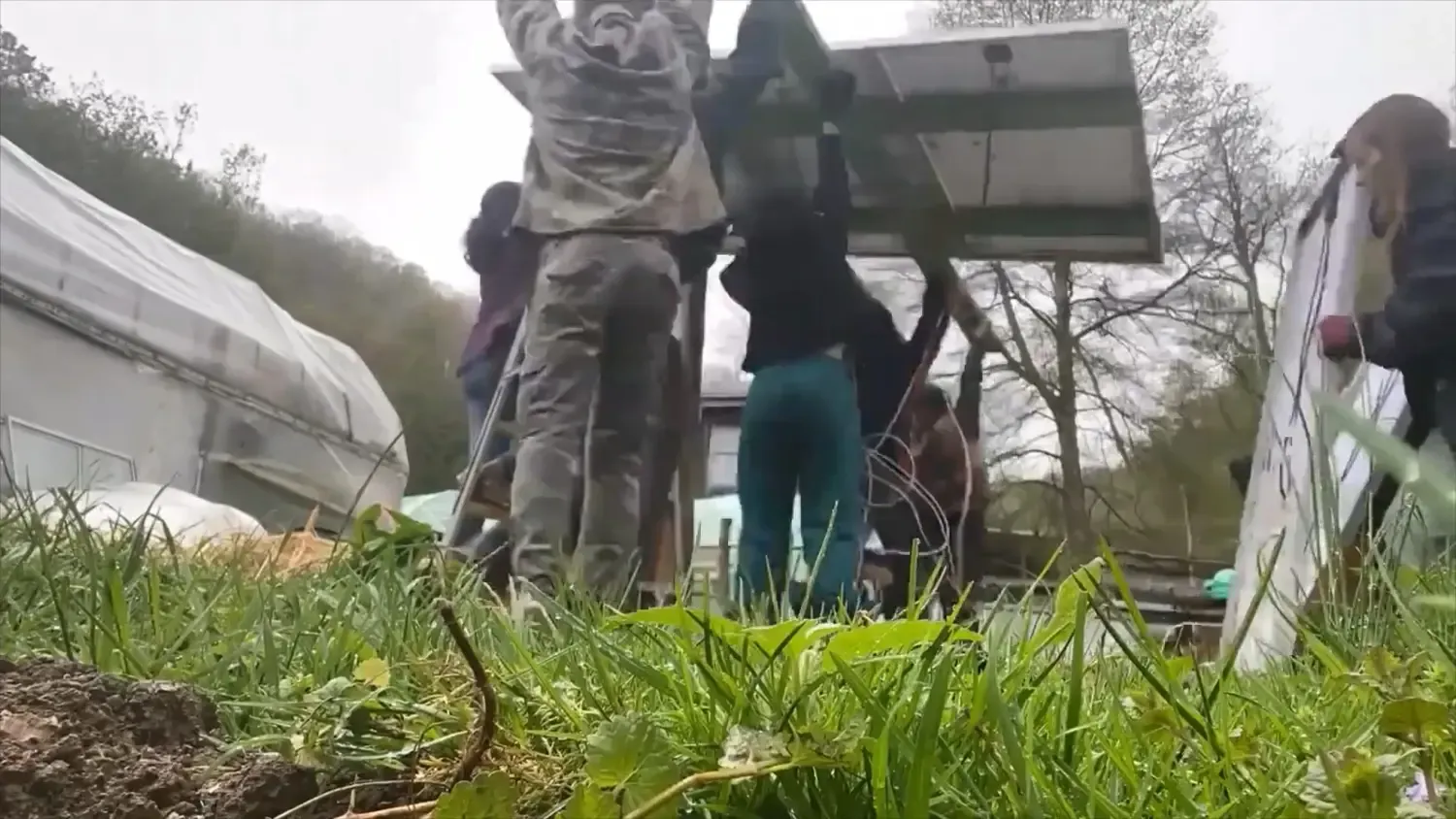 Everyone at the farm helping lift the tracker up into its final home